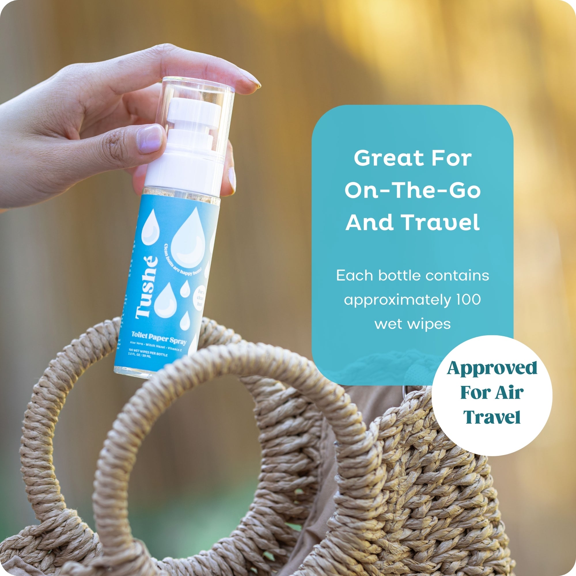 Dark blue Tushe toilet paper spray bottle placed into beach bag. Great to use for on-the-go and approved for air travel. 2.0 fl. oz. bottle is about 100 wet wipes.